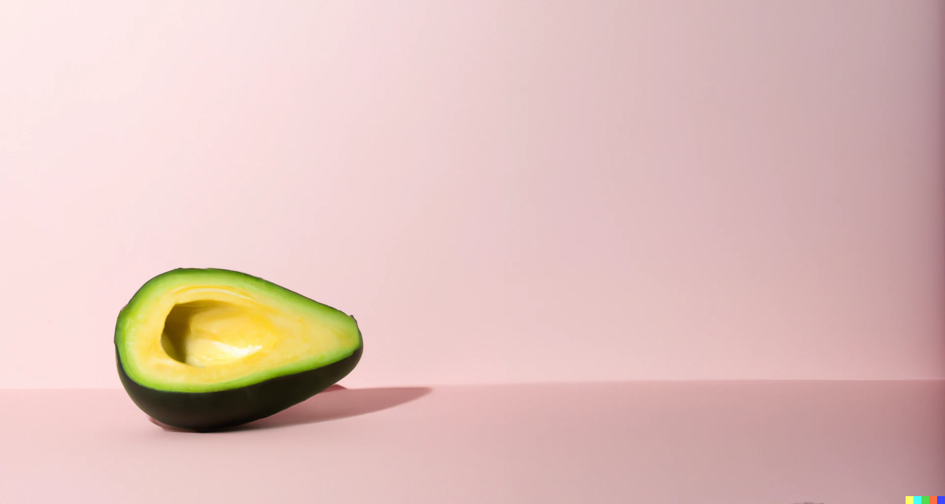 An avocado on a pink background