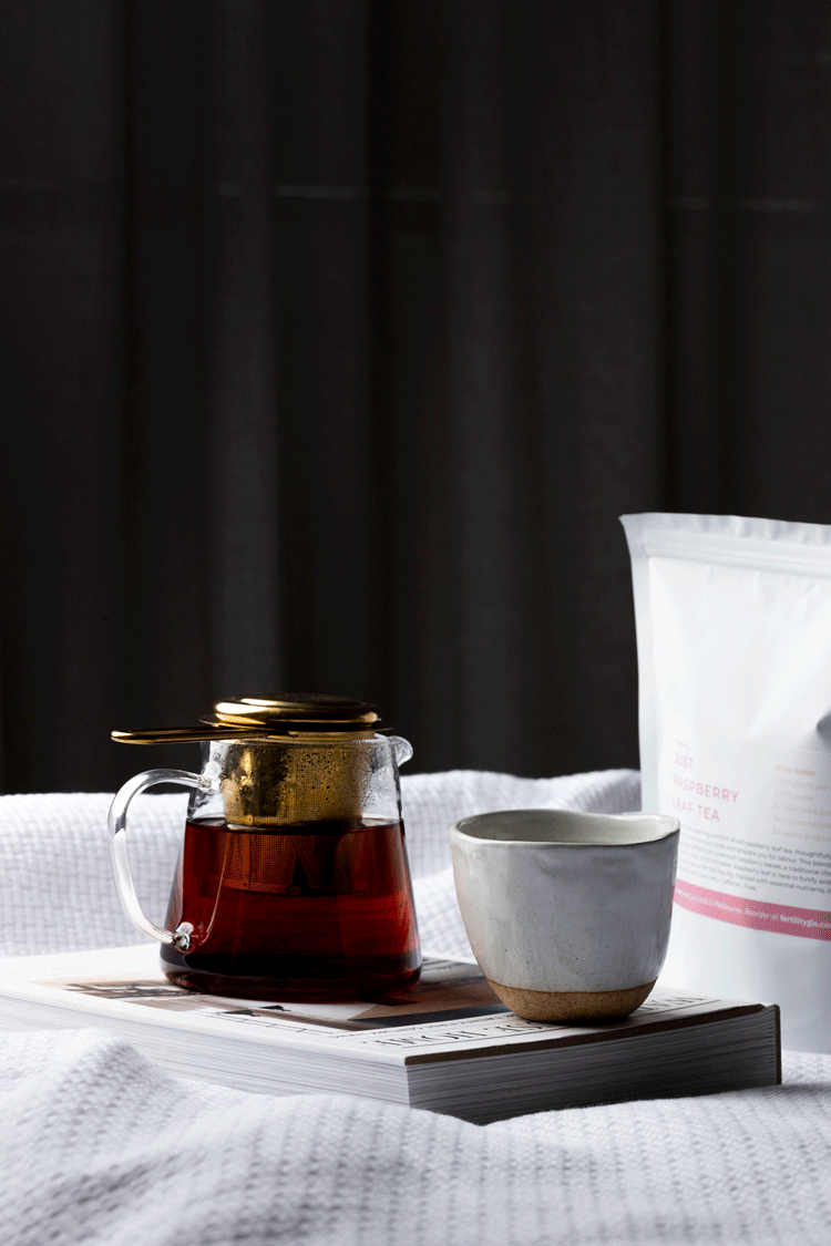 pouring raspberry leaf tea in mug